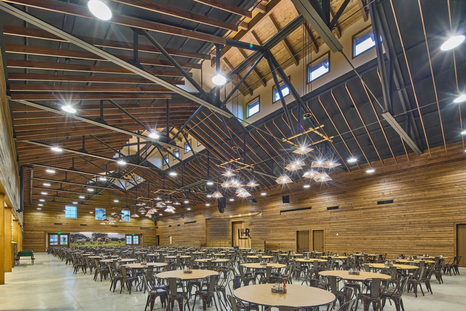 The timber-beamed 20,000 square foot dining hall at LoneHollow Ranch in Texas